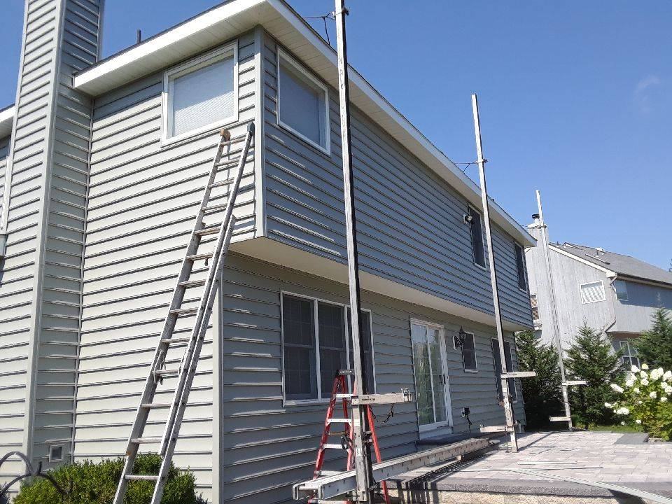 A ladder leaning up against the side of a house.