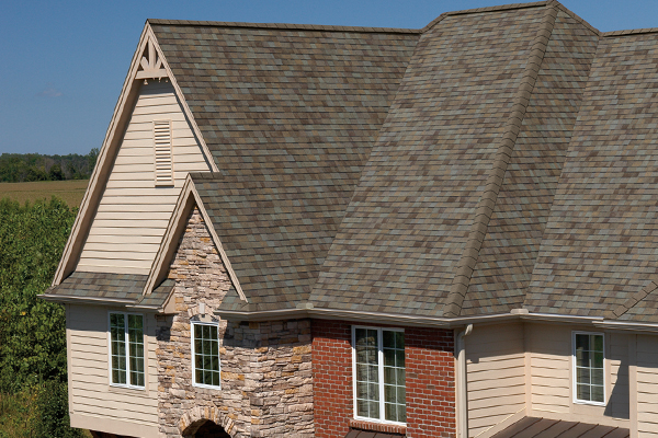 A large house with a brick wall and stone trim.